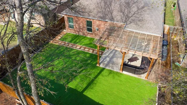 a view of a backyard with wooden fence