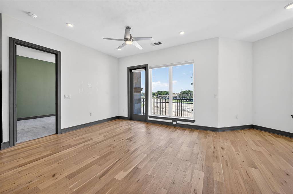 2700 Old Denton Road, Unit 2259 Carrollton, TX 75007 - Photo 18 of 39 a view of an empty room with wooden floor and a window