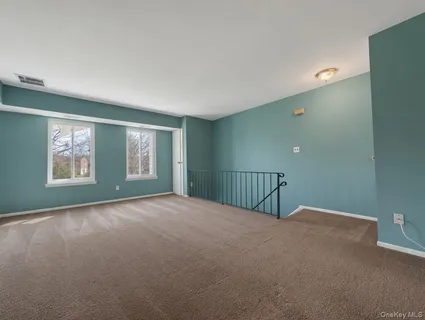 a view of an empty room with windows