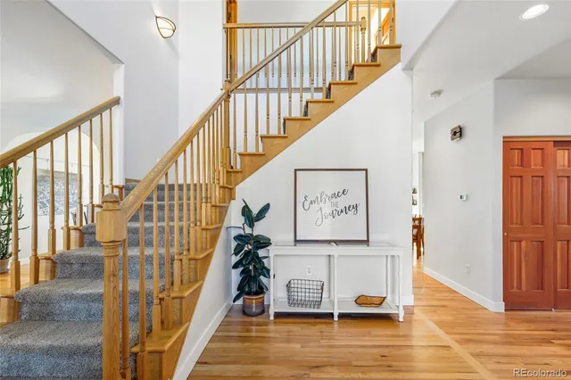 a view of entryway with wooden floor and stairs