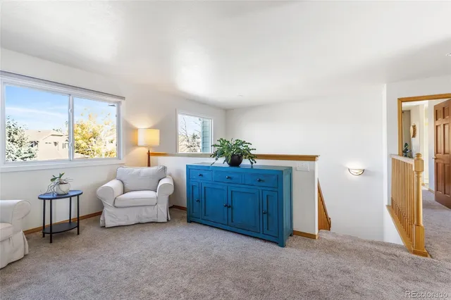 a living room with furniture and a dresser