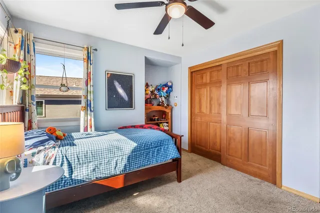 a bedroom with bed and wooden floor