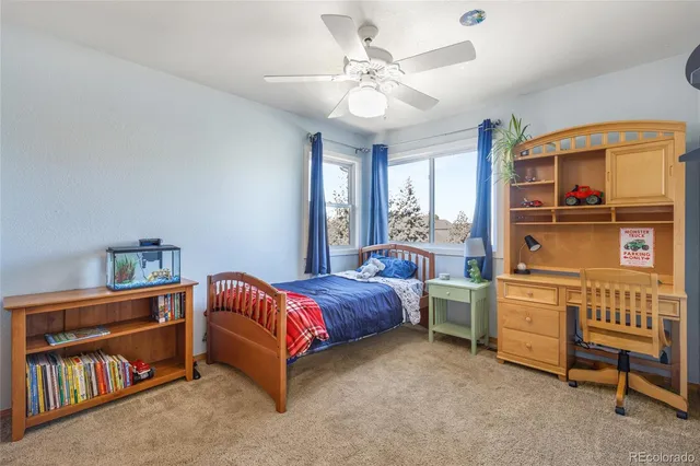 a bed room with a bed and a chair