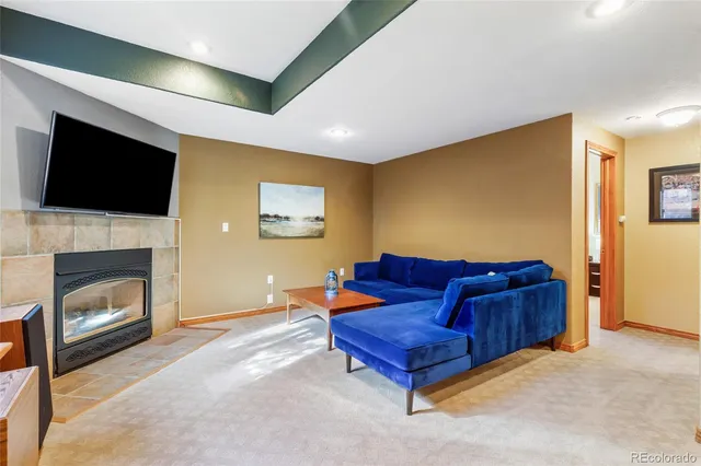 a living room with furniture fireplace and flat screen tv