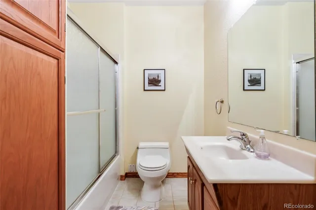 a bathroom with a toilet a sink and a mirror