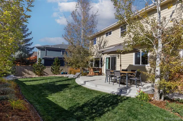 a view of a house with backyard sitting area and garden