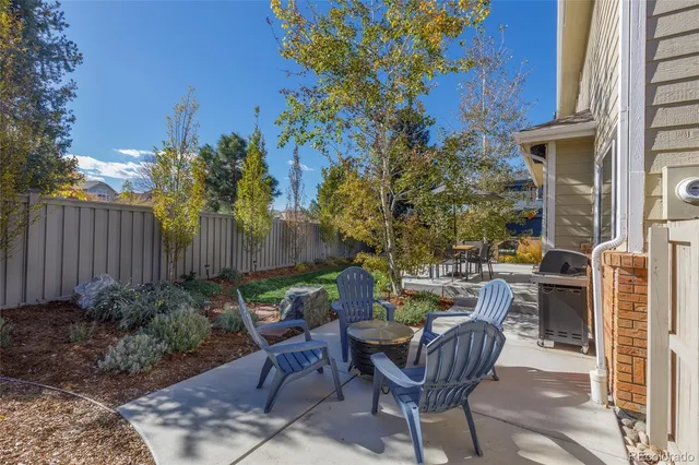 a view of a patio with table and chairs and potted plants