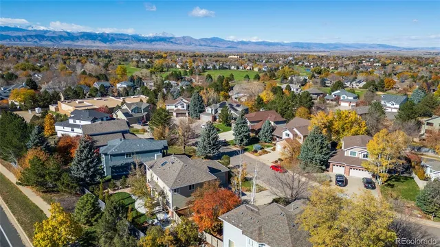 an aerial view of residential houses with outdoor space and ocean view