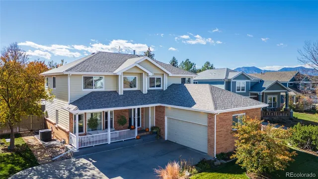 a front view of a house with a yard and balcony