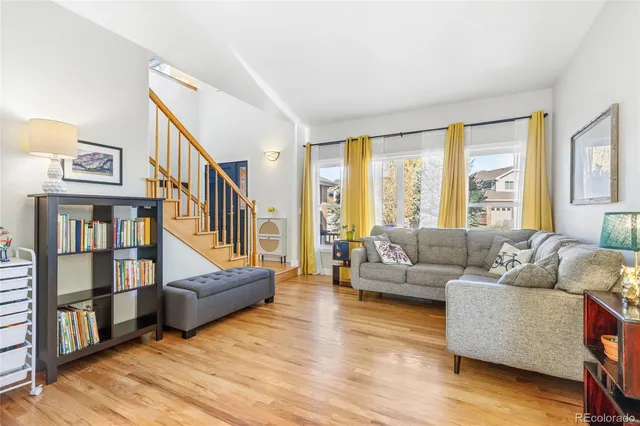 a living room with furniture and a book shelf
