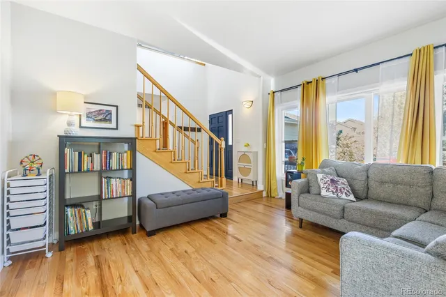 a living room with furniture and a book shelf