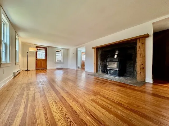 a view of a room with wooden floor and window