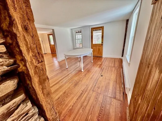 a view of a room with wooden floor and windows