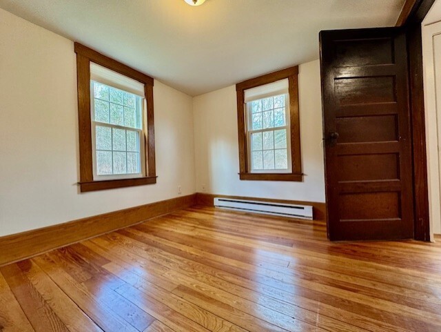 567 Firetown Road Simsbury, CT 06070 - Photo 17 of 39 an empty room with wooden floor closet and windows