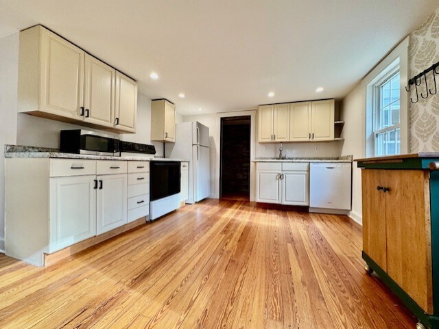 567 Firetown Road Simsbury, CT 06070 - Photo 3 of 39 a kitchen with granite countertop a stove top oven a sink dishwasher and a refrigerator with wooden floor
