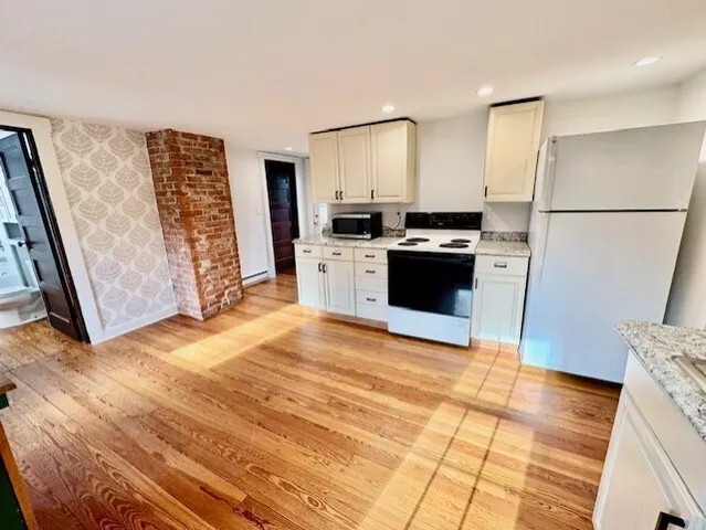 a kitchen with stainless steel appliances granite countertop a refrigerator stove and sink