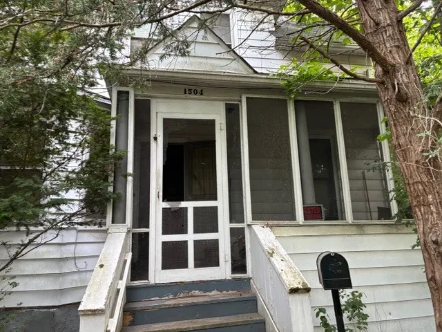 a view of front door of house with stairs
