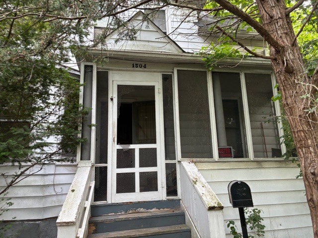 a view of front door of house with stairs