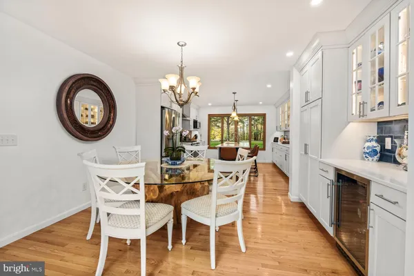 a dining room with furniture a chandelier and wooden floor