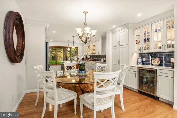a spacious bedroom with a bed a mirror and a large window