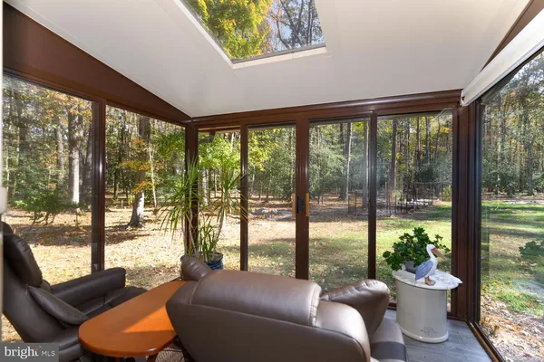 a bedroom with a bed and dresser with mirror