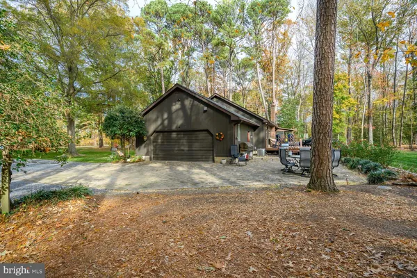 a front view of a house with a yard table and chairs