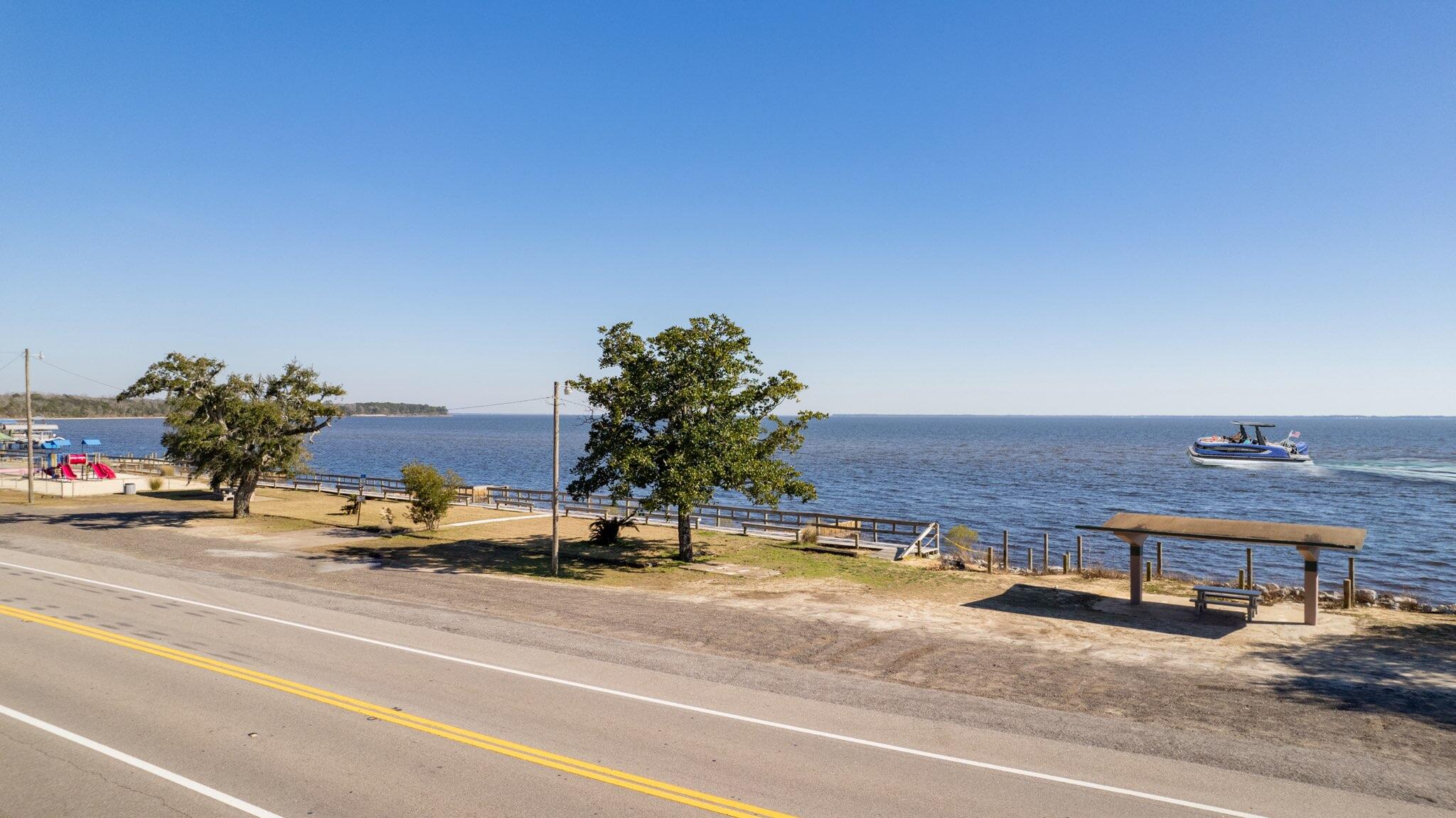 Lot 29 West State Highway Freeport, FL 32439 - Photo 2 of 17 a view of a city street with a parked car