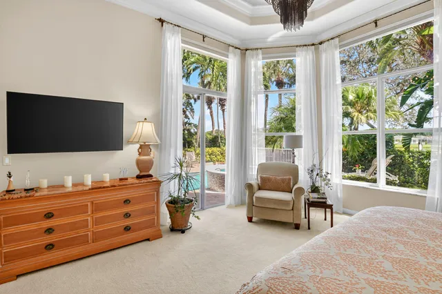 a view of a house with swimming pool and sitting area