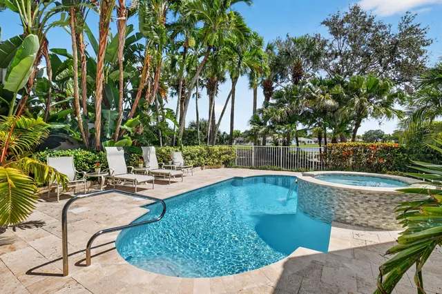 an aerial view of residential house with outdoor space and swimming pool