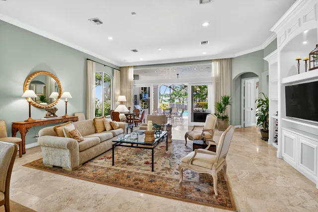 a view of a dining room with furniture and a chandelier