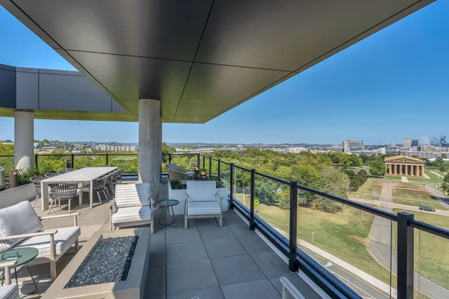 a view of a balcony with an outdoor seating
