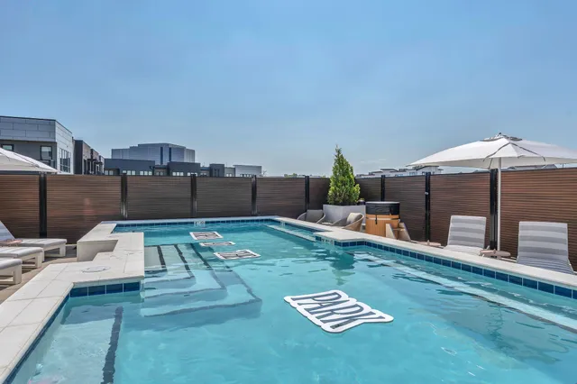 a living room with furniture a rug and gym equipment