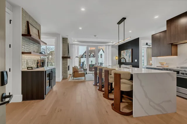 a kitchen with a sink stainless steel appliances a counter top space and cabinets