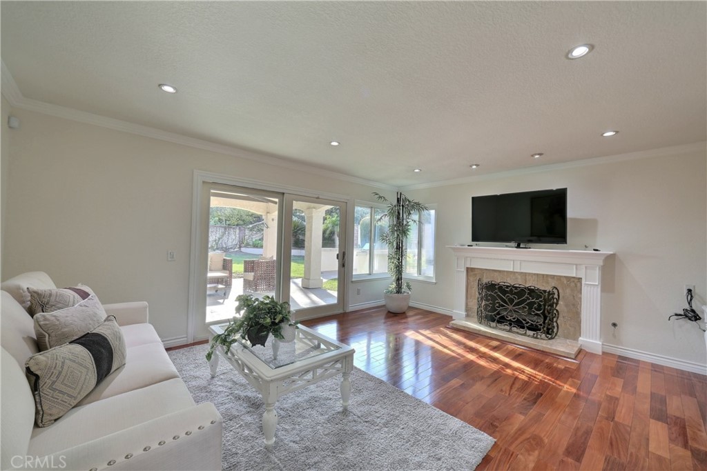 19271 Kamlyn Lane Walnut, CA 91789 - Photo 11 of 29 a living room with furniture a flat screen tv and a fireplace