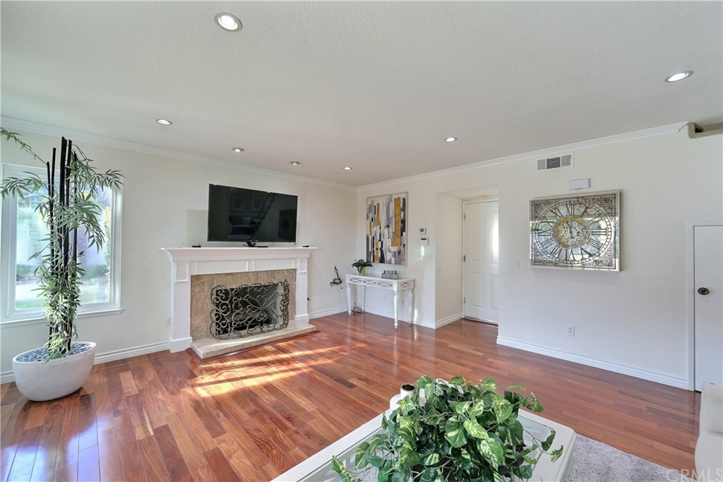 19271 Kamlyn Lane Walnut, CA 91789 - Photo 14 of 29 a living room with furniture a fireplace and a potted plant