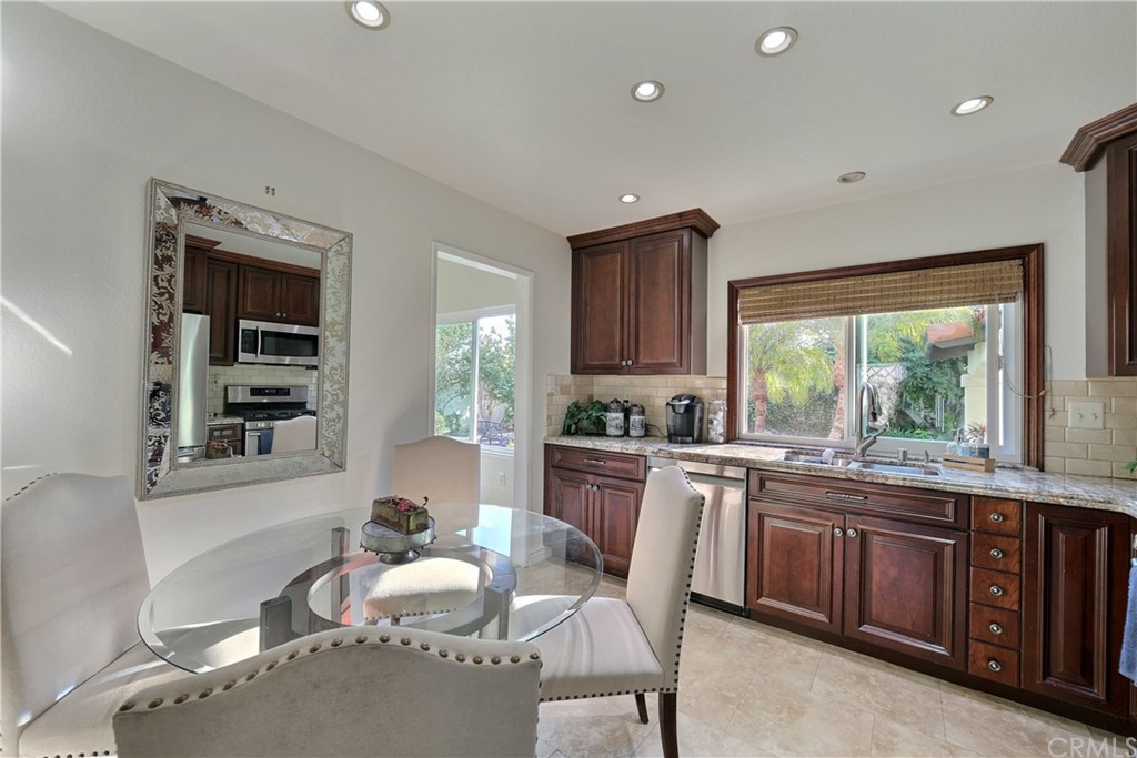 19271 Kamlyn Lane Walnut, CA 91789 - Photo 9 of 29 a kitchen with a table chairs sink and cabinets