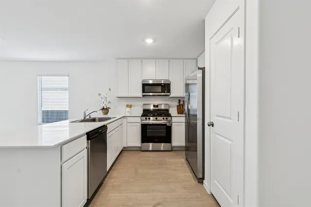 a view of kitchen and refrigerator