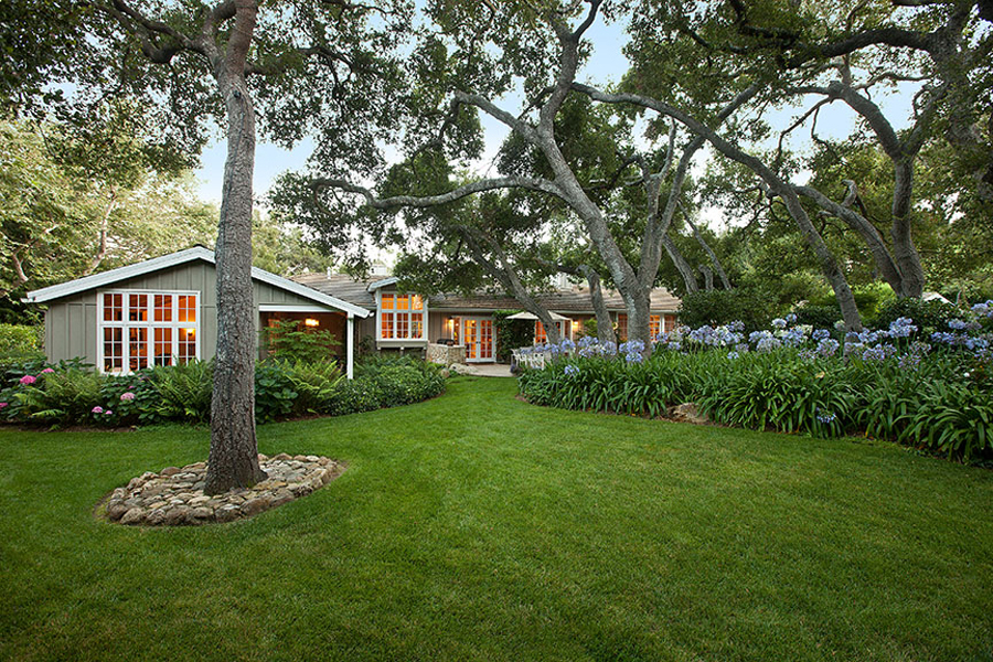 2140 Veloz Drive Montecito, CA 93108 - Photo 12 of 16 a front view of a house with a garden and trees