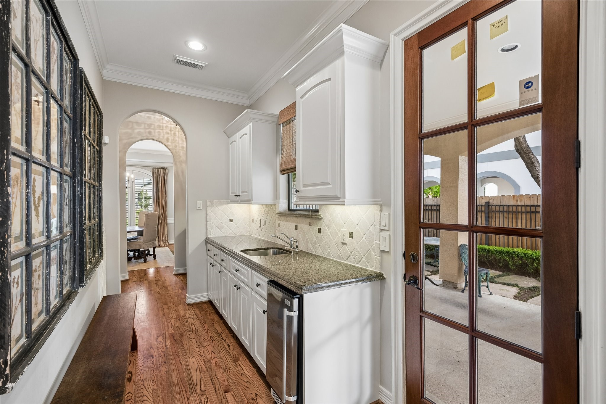 802 Anderson Street Bellaire, TX 77401 - Photo 15 of 36 This is the view from the kitchen towards the dining room. The exterior door allows entry from the porte cochere, into the mudroom with cabinets, sink, and brand new ice maker. This leads to the butler's pantry and then to the dining room.