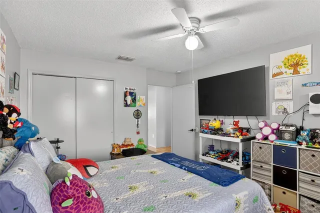 a bedroom with furniture and a flat screen tv