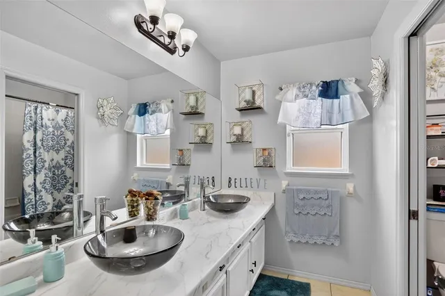 a bathroom with sink a mirror and shower