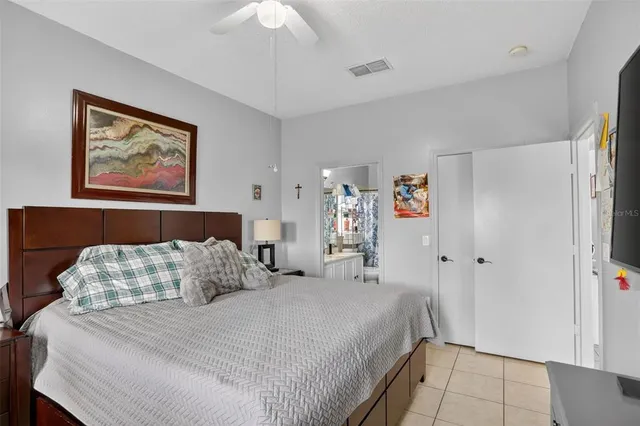 a bedroom with bed and a chandelier