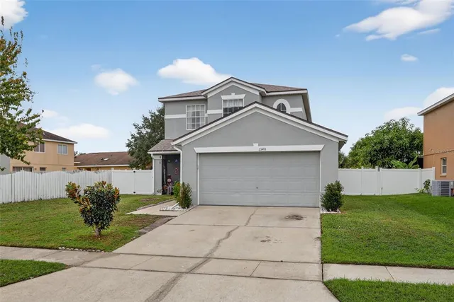 a front view of a house with a garden and plants