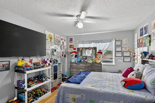 a bedroom with furniture and a flat screen tv