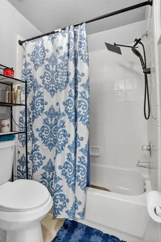 a bathroom with a toilet and shower
