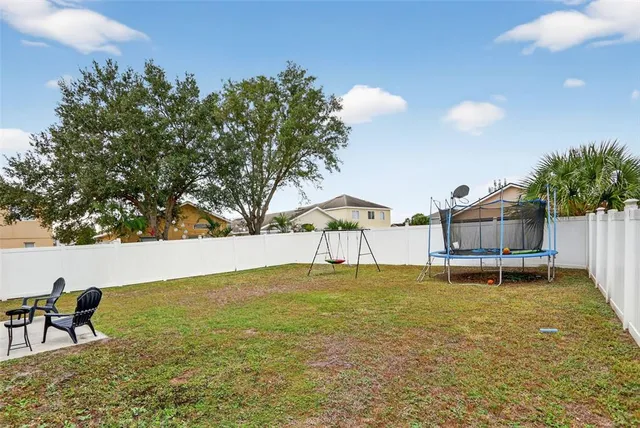 a view of a house with a yard and sitting area
