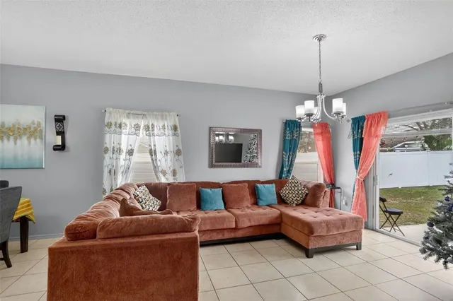 a living room with furniture and a chandelier
