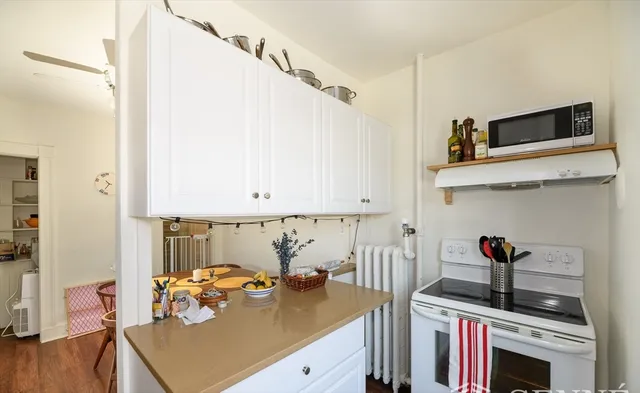 a kitchen with stainless steel appliances a stove a sink and a refrigerator