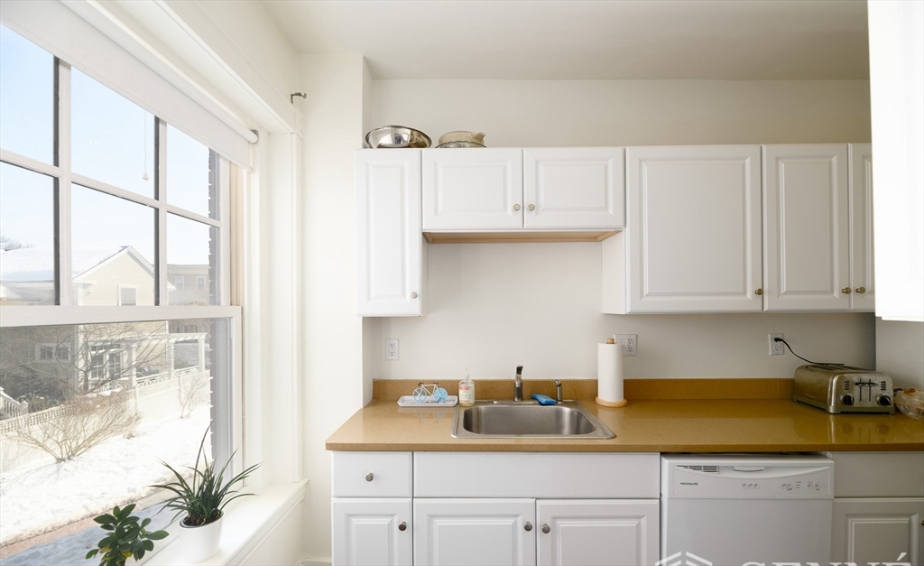 55 Magazine Street, Unit 23 Cambridge, MA 02139 - Photo 2 of 14 a kitchen with a sink a stove and white cabinets