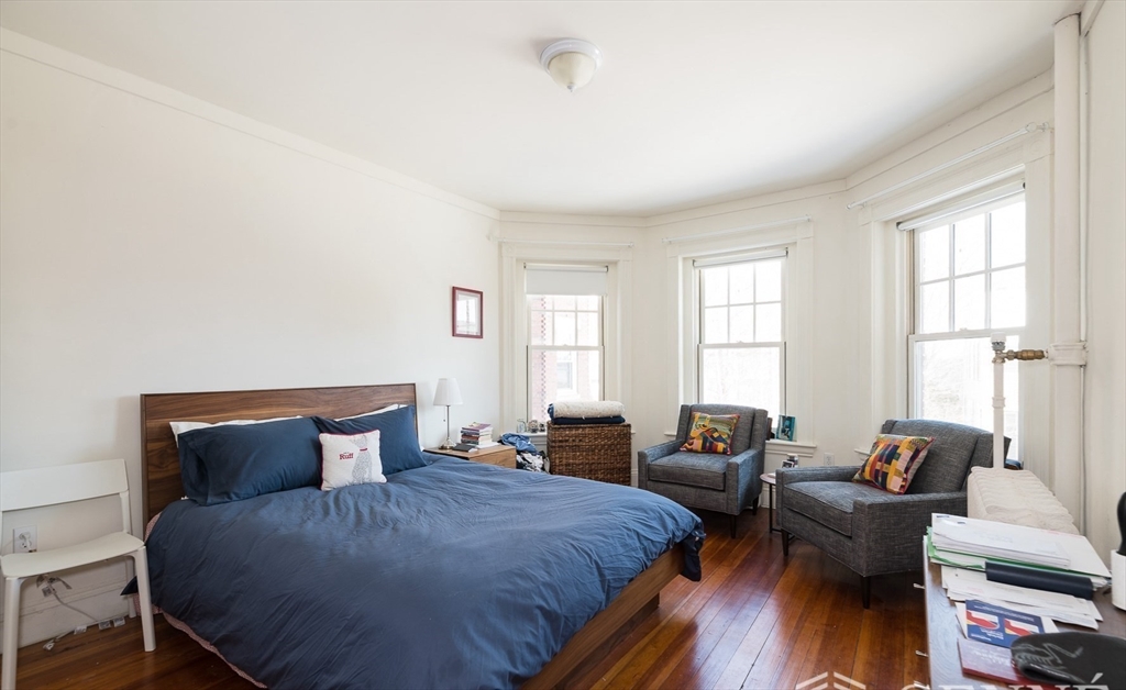 55 Magazine Street, Unit 23 Cambridge, MA 02139 - Photo 5 of 14 a spacious bedroom with two beds and a couch